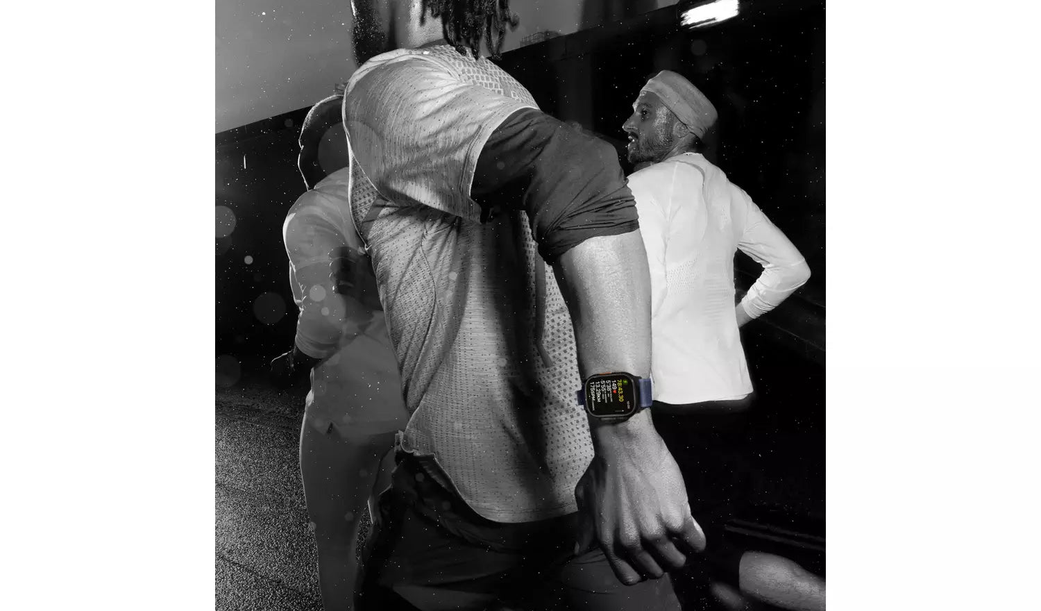 Smartwatch on a wrist with black Milanese-style band during outdoor activity