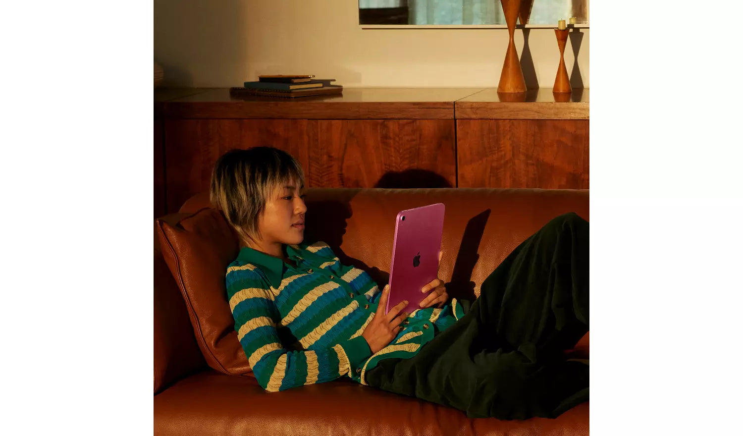 Pink iPad held in hands with the back facing the camera